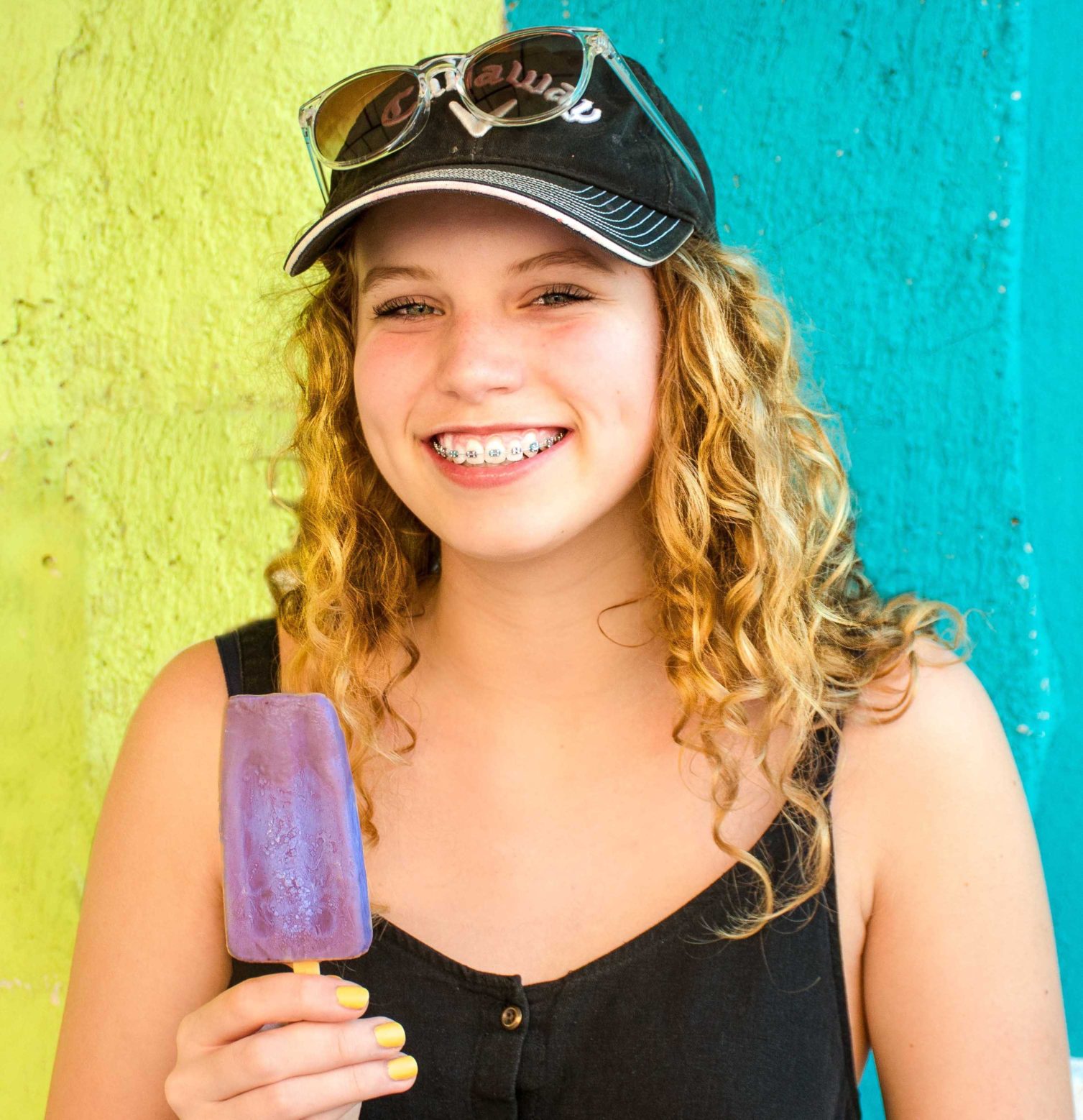Dr Randal McAlister: teenager wearing braces Teenage girl wearing braces and eating an ice block